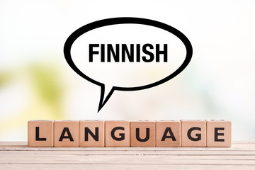 Finnish language lesson sign on a table