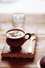 cup of hot chocolate and a chocolate muffin