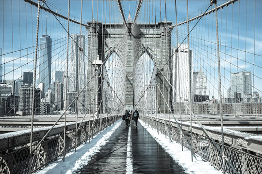 Winter in New York / Pedestrians cross snow-covered Brooklyn Bridge in February 2015