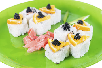 closeup of sushi roll with tuna and orange, shallow DOF