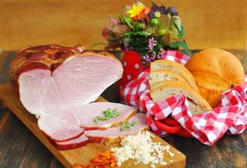 Delicious smoked ham on a wooden board with spices
