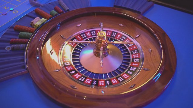 Roulette wheel - groupier spins the wheel - ball lands on field 10 black