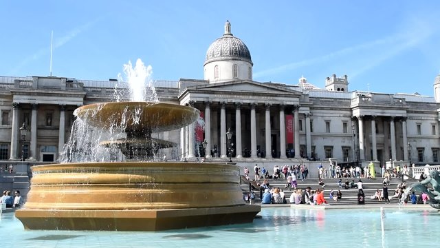 LONDON -JUNE 2015: Trafalgar Square with tourists. London attracts 30 million people annually