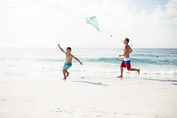 Father and son playing with kite 