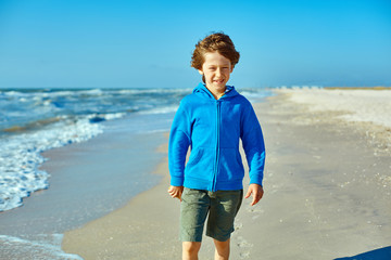 Fototapeta na wymiar boy on the sunny beach 