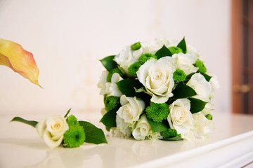 Wedding bouquet and boutonniere of white flowers 