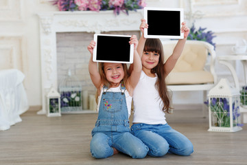 two little girls with tablet computer