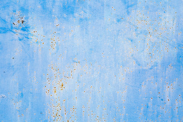 Old blue cracked paint on metal background