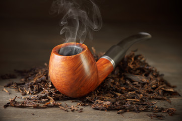 Pipe on tobacco pile - 106678075