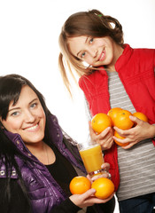 Fototapeta na wymiar child with mother holding oranges and juice