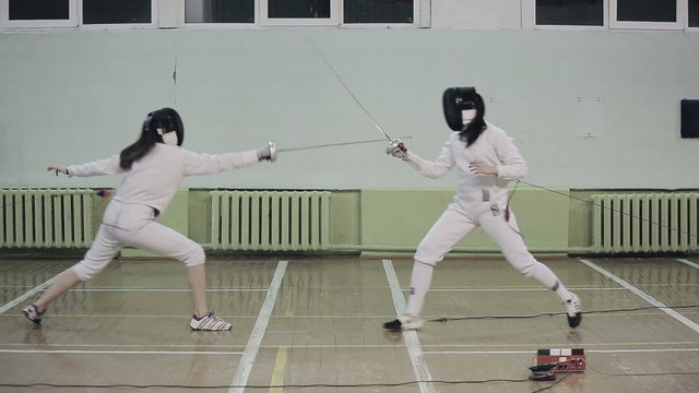 People practicing fencing duel