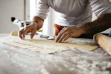 Making ravioli on a wooden table and tools - 106679205