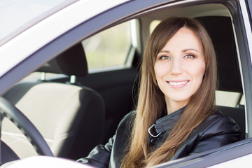 Fototapeta na wymiar Young confident car driver woman steering wheel.