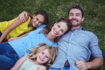 High angle view of happy family lying on field