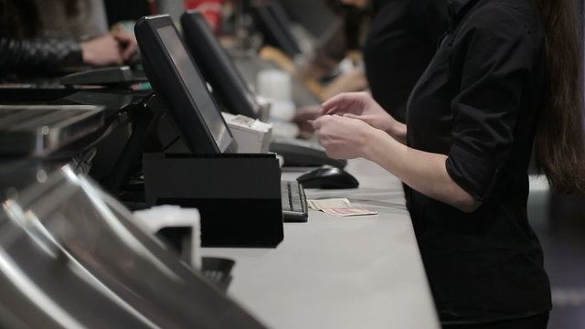 Cash register in the shop. Employees and buyers