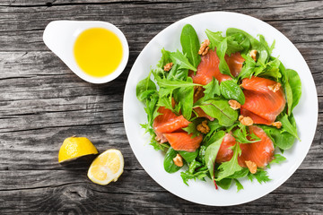 Red fish healty salad on white dish