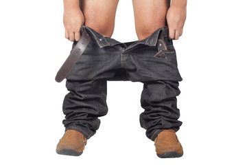 Young adult asian man pulls up his dark jeans, rear view, close-up studio. Isolate on white background
