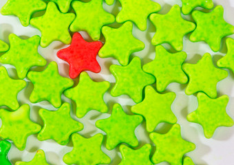 Red and green Star candies on white background