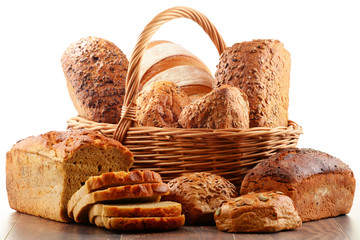 Wicker basket with assorted baking products isolated on white