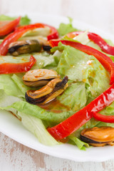 salad with seafood on white dish on white background