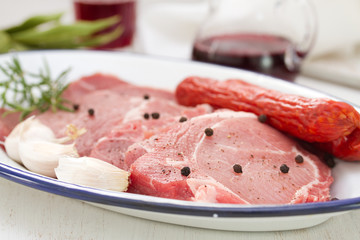pork with black pepper, smoked sausages and garlic on dish