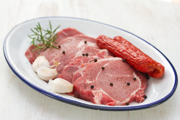 pork with smoked sausages and garlic on dish