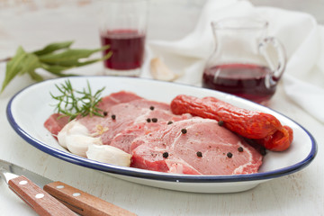 pork with black pepper, smoked sausages and garlic on dish