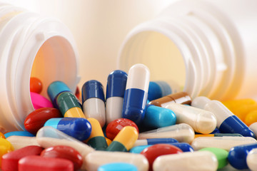 Composition with variety of drug pills and container
