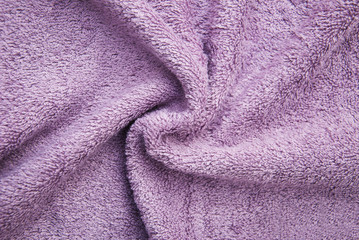 Fototapeta na wymiar Purple bath fluffy towel