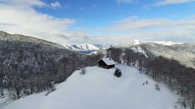Drone flying over log cabin in Pyrenees Mountains