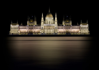 Fototapeta premium City Night. Reflection of Houses of Parliament in Budapest, Hungary.