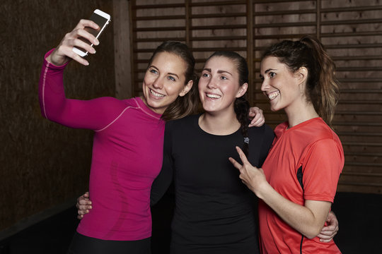 Happy Young Women In Gym Taking A Selfie