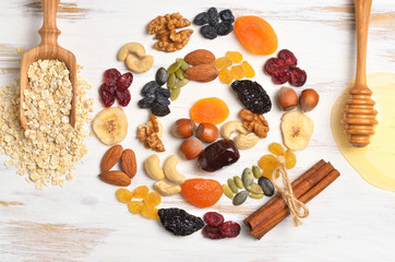 Granola bars ingredients on white wood background, top view.