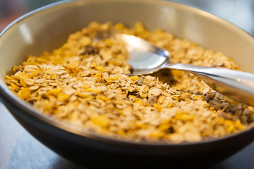 close up of bowl with granola or muesli and spoon