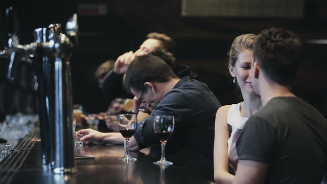 Row of people drinking at a bar