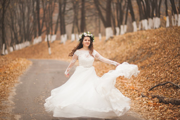 Beautiful bride posing in park and forest autumn