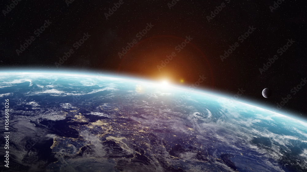 Wall mural sunrise over planet earth in space