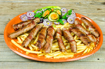 Rolled kabobs in bacon on an old wooden table