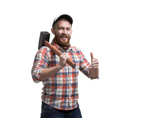 Redhead Bearded man wearing a baseball cap and shirt holding a hammer with an expression. Thumbs...