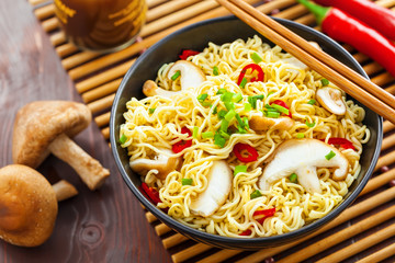 Instant noodles with shiitake mushrooms in a bowl, Asian traditional food, top view