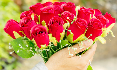 Woman Holding Artificial flowers Red Roses
