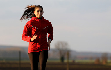 Young female runner in evening sun