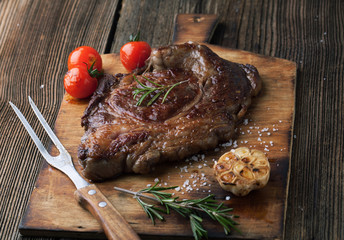 Grilled ribeye steak marbled meat with  rosemary and garlic