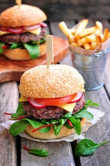 Homemade beef burger with vegetables and french fries.