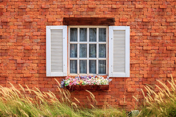 White window on the orange wall.