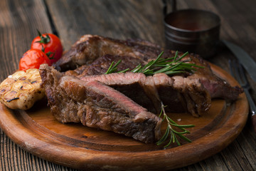 Grilled ribeye steak marbled meat with salt, olive oil, rosemary