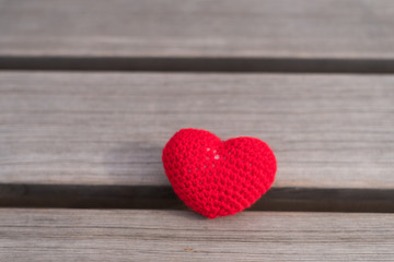 Fototapeta premium Crocheted heart on a wooden board