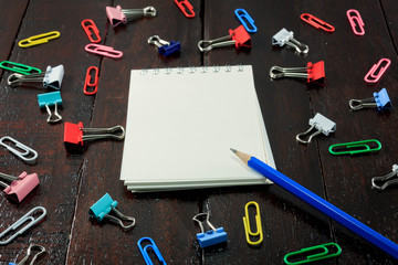 selective focus blue pencil,notebook,colorful stamp paper clip o