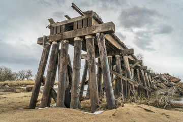 Fototapeta na wymiar destroyed railroad timber trestle