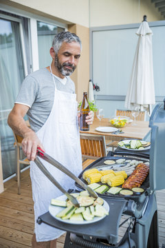 Man Barbecuing On His Balcony